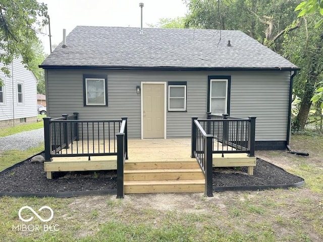 rear view of property with a wooden deck