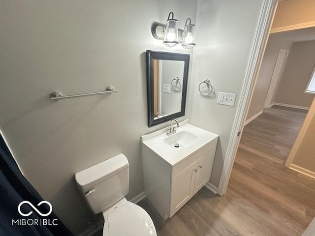 bathroom featuring hardwood / wood-style flooring, vanity, and toilet