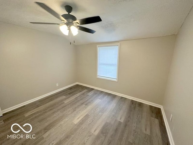 unfurnished room with ceiling fan, dark hardwood / wood-style floors, and a textured ceiling