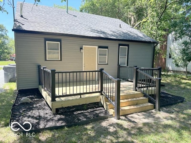 rear view of property featuring a wooden deck