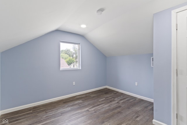 bonus room with dark hardwood / wood-style floors and lofted ceiling