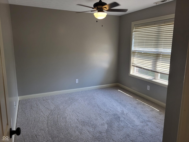 spare room featuring carpet floors and ceiling fan