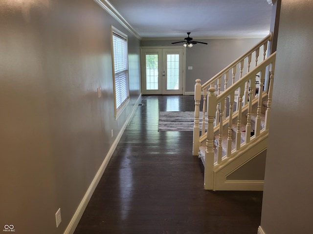 hallway with dark hardwood / wood-style flooring, ornamental molding, and french doors