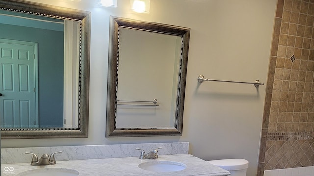 bathroom with vanity, walk in shower, and toilet