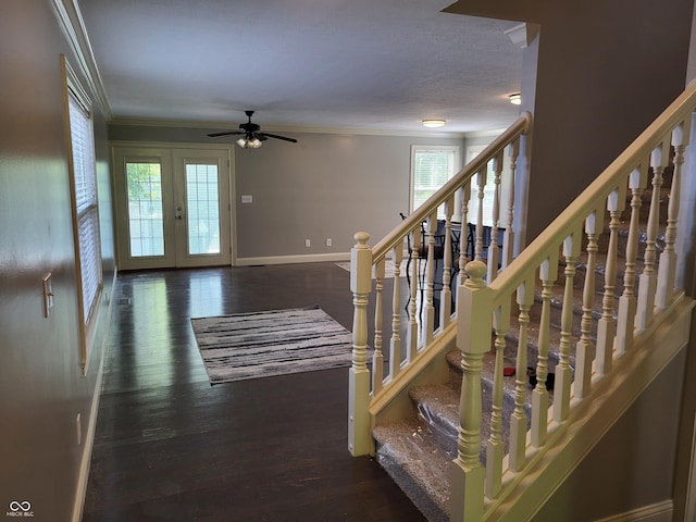 staircase with ornamental molding, wood-type flooring, ceiling fan, and french doors