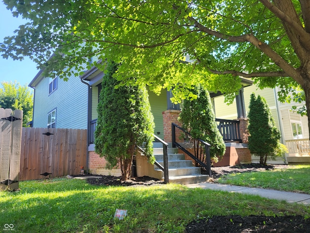 obstructed view of property with a front lawn