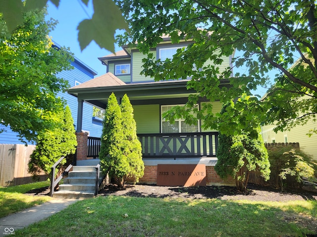 view of front facade with a porch and a front lawn