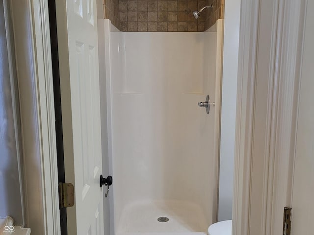 bathroom featuring toilet and walk in shower