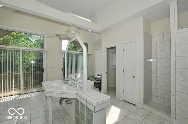 bathroom with tile patterned floors, ceiling fan, and sink