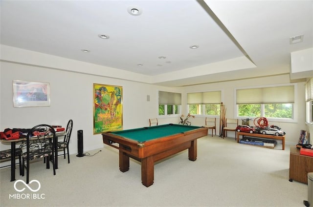 playroom with light colored carpet, a wealth of natural light, a tray ceiling, and billiards