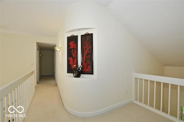 corridor featuring carpet floors and vaulted ceiling