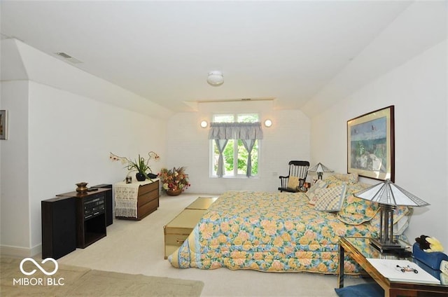 bedroom featuring lofted ceiling and light carpet