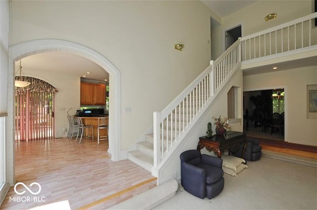 staircase with hardwood / wood-style floors