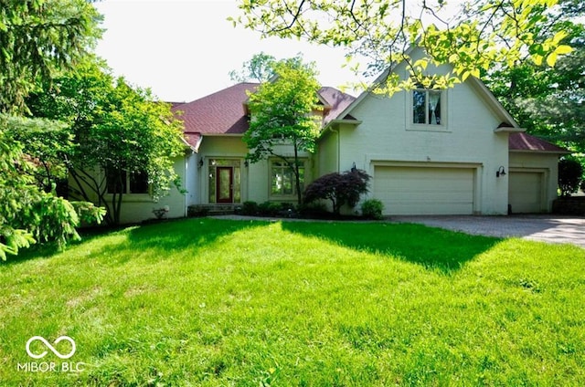 view of front of house featuring a front lawn and a garage