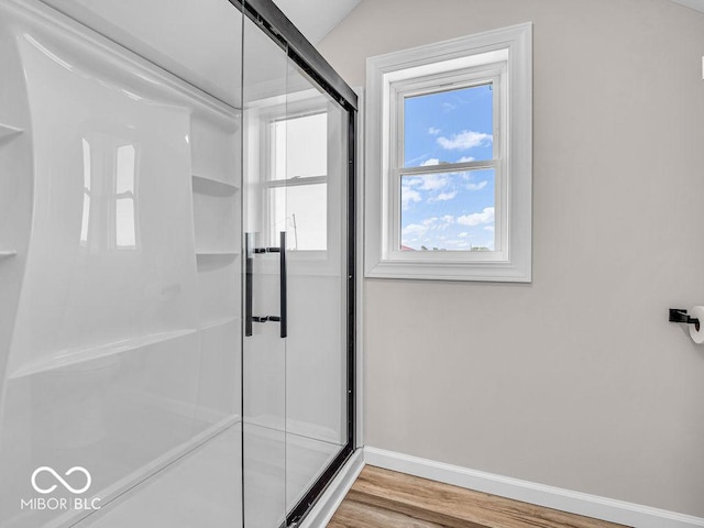 bathroom featuring a shower with door and hardwood / wood-style flooring