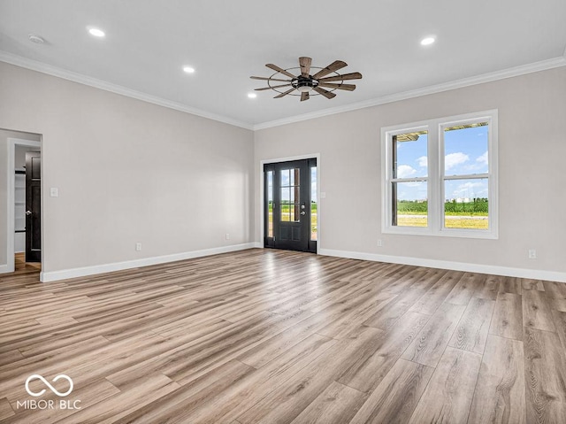 unfurnished room with crown molding, ceiling fan, and light wood-type flooring