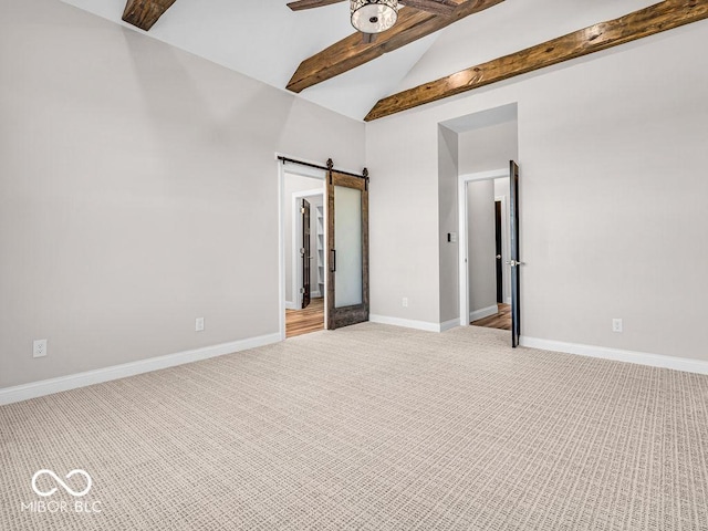 carpeted empty room with beam ceiling, a barn door, high vaulted ceiling, and ceiling fan