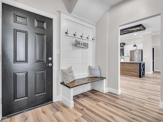 mudroom featuring crown molding and light wood-type flooring