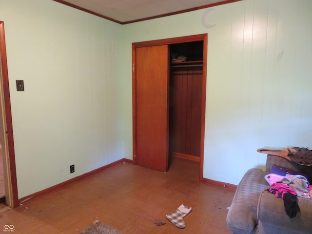 bedroom featuring ornamental molding and a closet