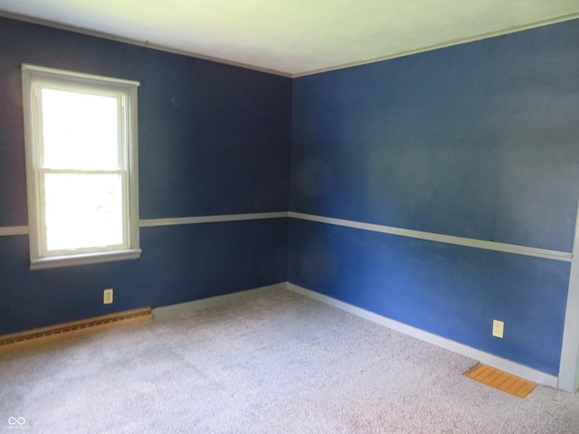 unfurnished room featuring carpet flooring and a baseboard radiator