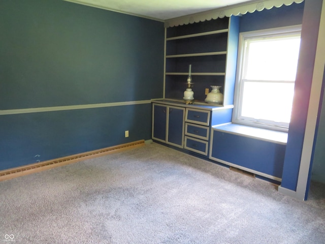 carpeted spare room featuring a wealth of natural light