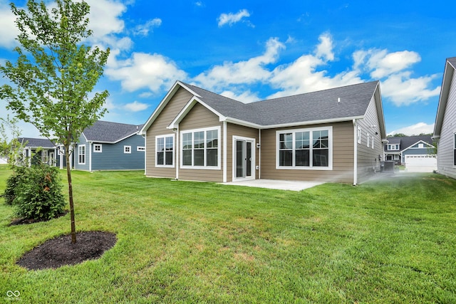 rear view of property featuring a yard and a patio