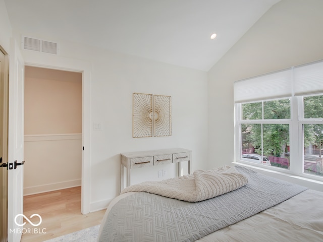 bedroom with light wood-style flooring, recessed lighting, visible vents, baseboards, and vaulted ceiling