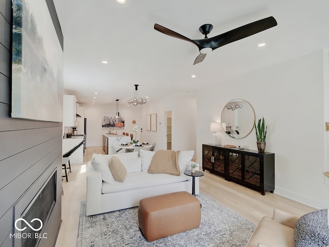 living room with ceiling fan, light wood-type flooring, baseboards, and recessed lighting