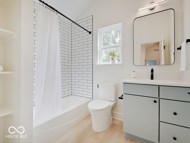 full bath featuring toilet, wood finished floors, shower / bathtub combination with curtain, vaulted ceiling, and vanity