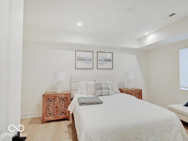 bedroom with baseboards, recessed lighting, visible vents, and light wood-style floors