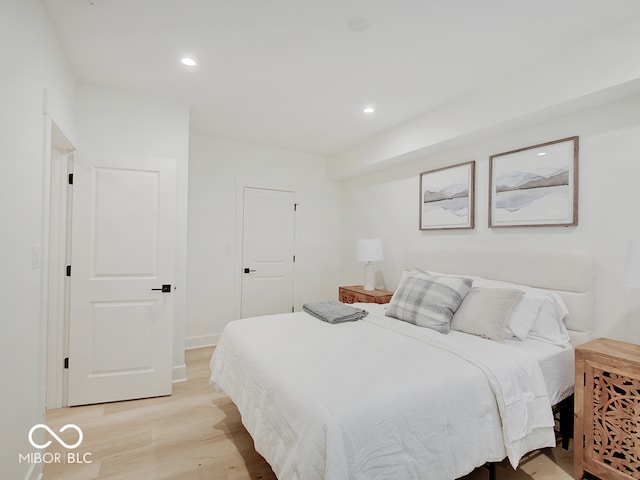 bedroom with light wood-style flooring and recessed lighting