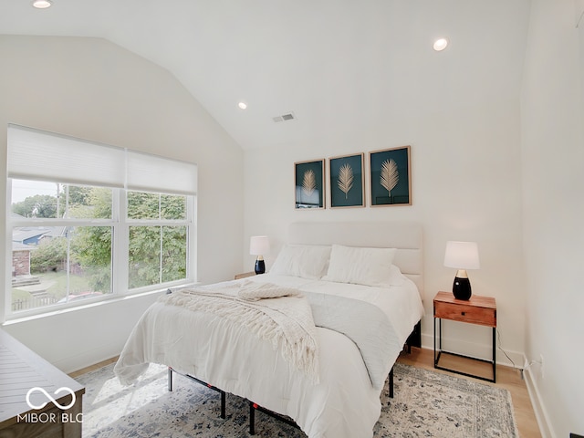 bedroom featuring recessed lighting, visible vents, vaulted ceiling, wood finished floors, and baseboards