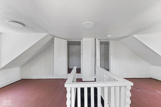 additional living space with lofted ceiling and hardwood / wood-style flooring