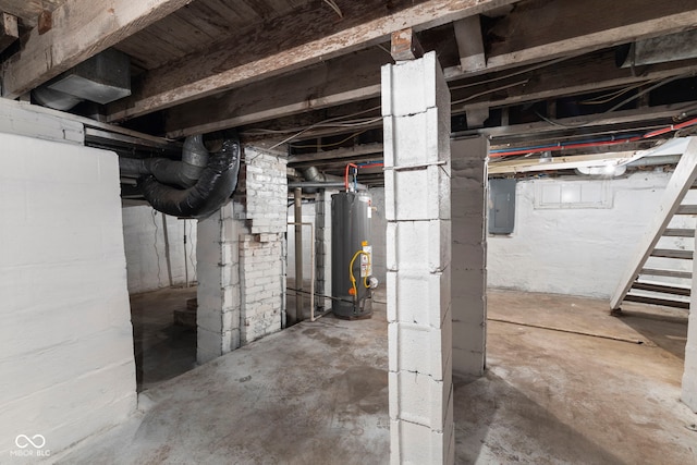 unfinished basement featuring electric panel and gas water heater