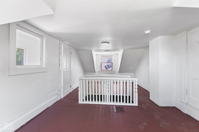 bonus room with dark hardwood / wood-style flooring