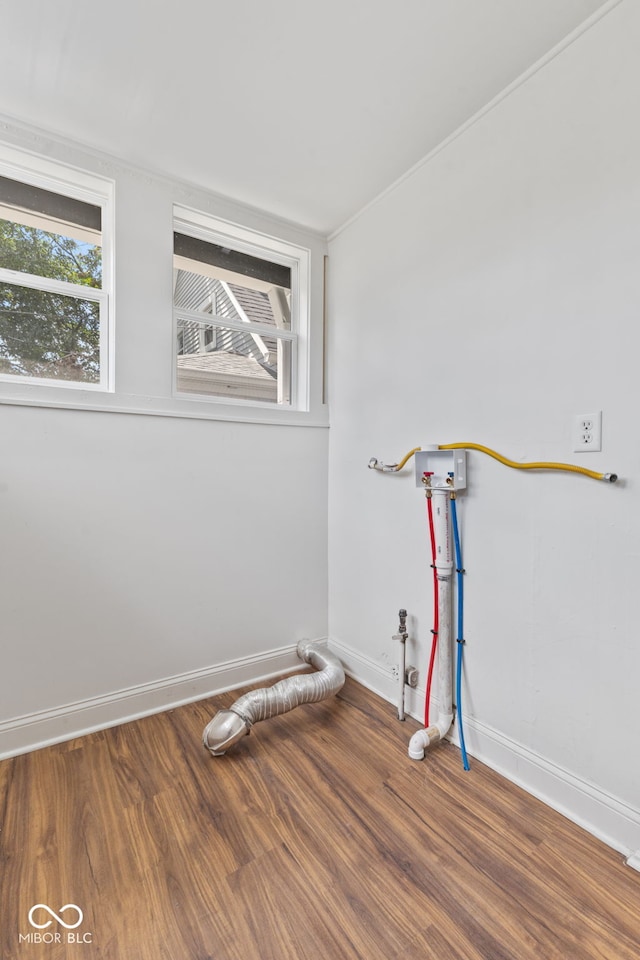 interior space featuring hookup for a washing machine and hardwood / wood-style floors