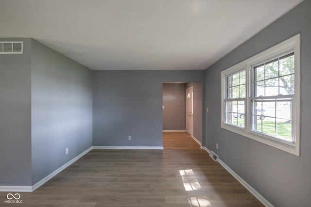 empty room with dark hardwood / wood-style floors