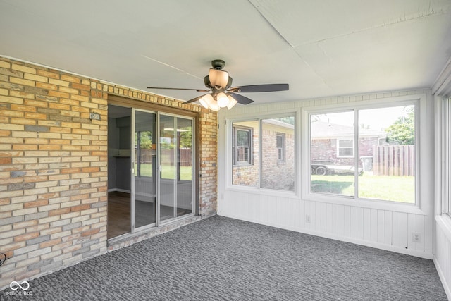 unfurnished sunroom featuring ceiling fan