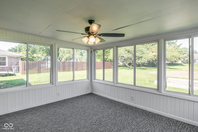 unfurnished sunroom with ceiling fan