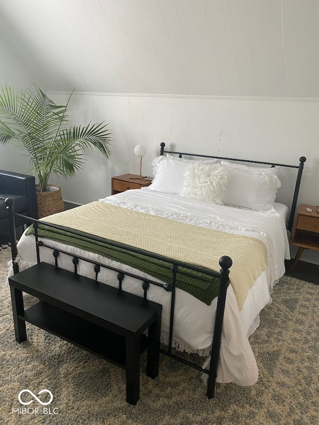 carpeted bedroom with lofted ceiling