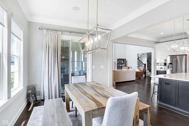 dining area with crown molding, dark wood-type flooring, and a notable chandelier