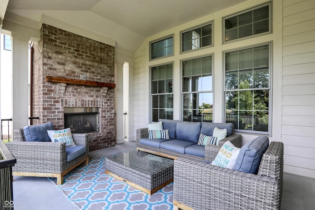 view of patio with an outdoor living space with a fireplace