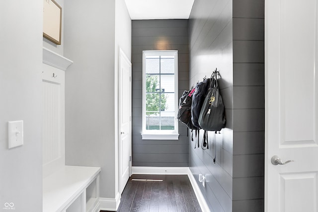 mudroom featuring dark wood finished floors and baseboards