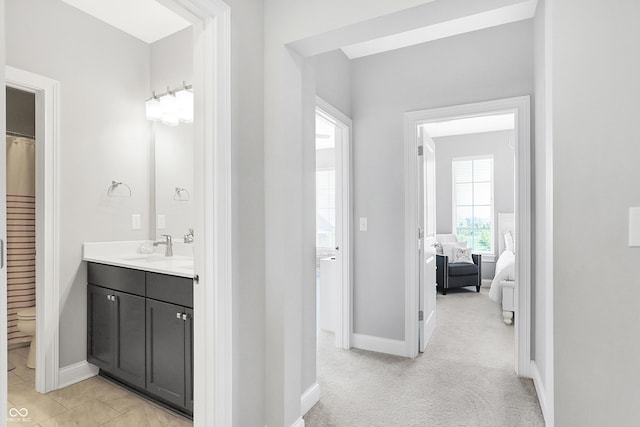 full bath with baseboards and vanity