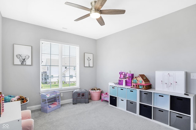 recreation room with carpet floors, ceiling fan, and baseboards