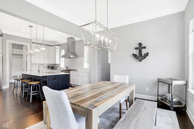 dining space featuring baseboards, ornamental molding, dark wood-type flooring, a chandelier, and recessed lighting