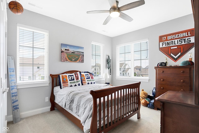 carpeted bedroom with a ceiling fan, visible vents, and baseboards