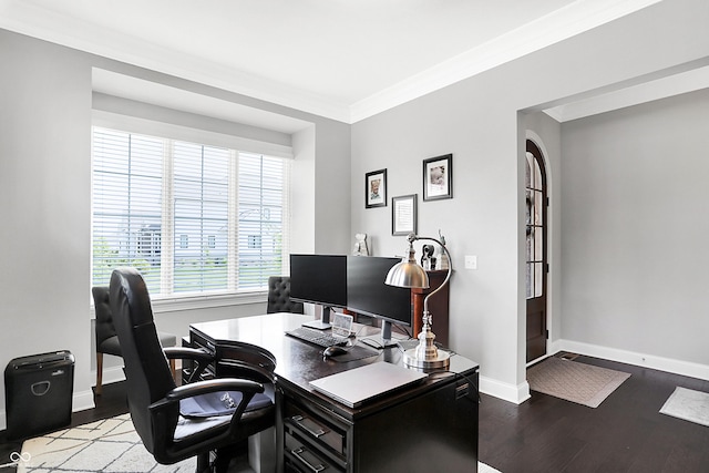 office area with arched walkways, ornamental molding, wood finished floors, and baseboards