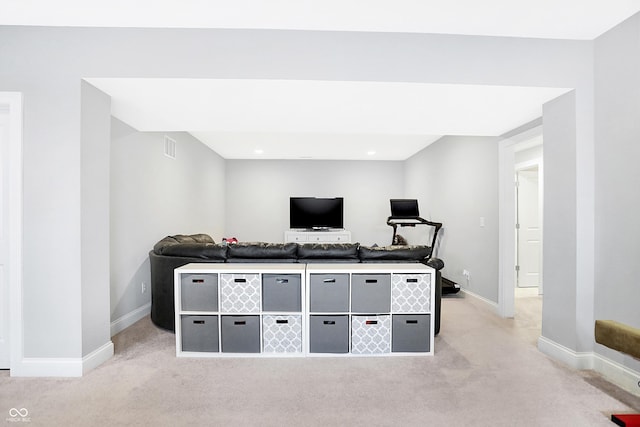 interior space with light carpet, visible vents, and baseboards