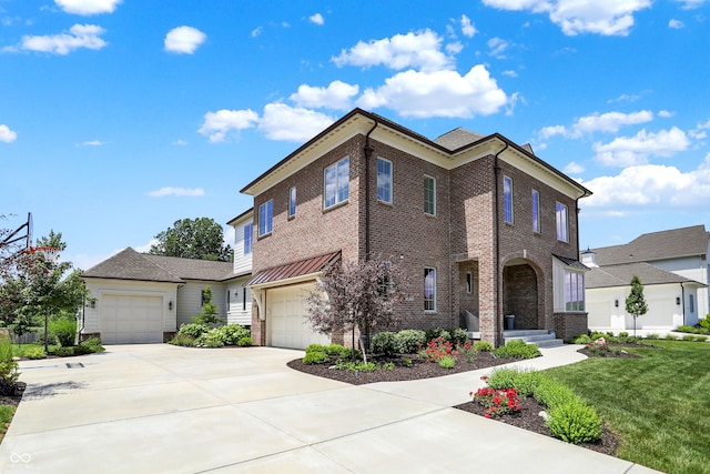 view of front of property featuring a front yard, brick siding, and driveway